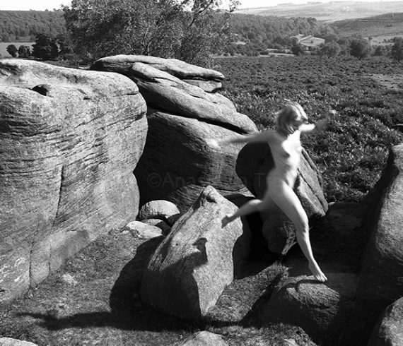 naked britain woman leaping from rocks