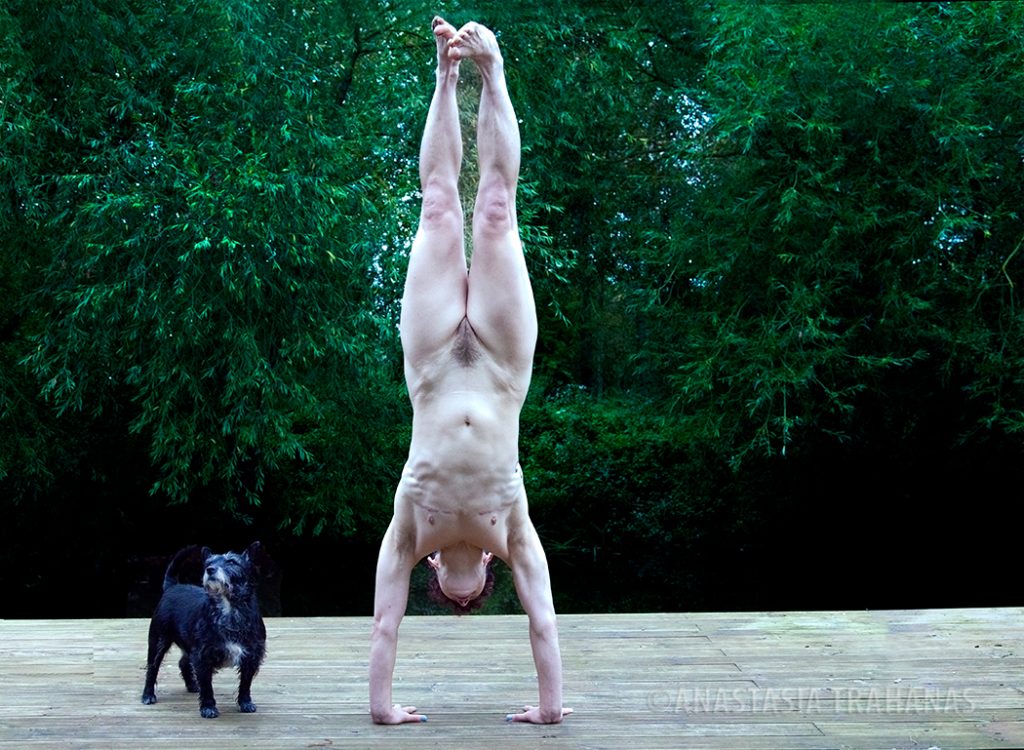 nude woman doing hand stand