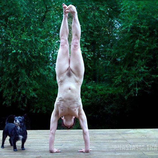 nude woman doing hand stand, dog, outdoor, transexual