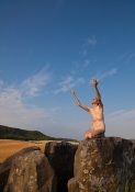 naked man worshipping the sun